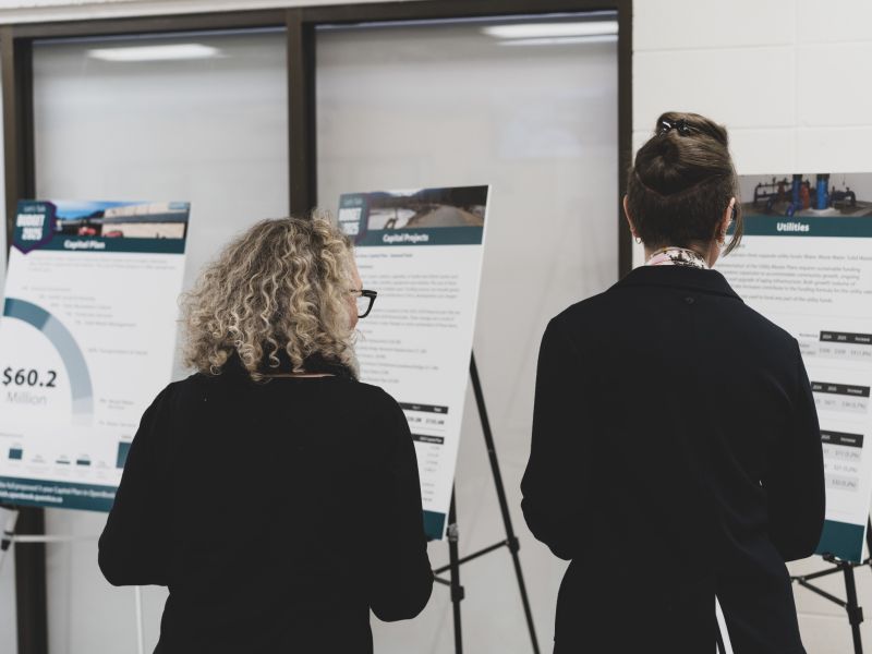 Two women read the information boards the budget open house held at Brennan Park Recreation Centre.